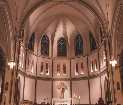 a large church with a cross in the middle of it