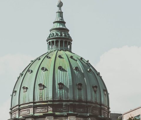 a large building with a green dome